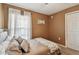 Bedroom featuring a plush bed, sheer curtains, and a neutral color scheme at 105 Blue Alice Spring Ct, Ruskin, FL 33570