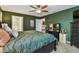 This bedroom features an ensuite bathroom and is painted with green walls at 105 Blue Alice Spring Ct, Ruskin, FL 33570
