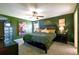Comfortable bedroom featuring contemporary art, a ceiling fan and natural light at 105 Blue Alice Spring Ct, Ruskin, FL 33570