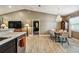 Open-concept dining area with modern chandelier, and a view into the bedroom at 105 Blue Alice Spring Ct, Ruskin, FL 33570