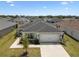 Charming single-story home features a manicured lawn, a two-car garage, and beautiful landscaping at 105 Blue Alice Spring Ct, Ruskin, FL 33570