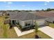 Aerial view of the home showcasing landscaping, roof, and driveway at 105 Blue Alice Spring Ct, Ruskin, FL 33570