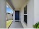 Charming covered front porch features a blue front door and 