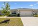 Beautifully landscaped home with a well-kept lawn and driveway, offering a great curb appeal at 105 Blue Alice Spring Ct, Ruskin, FL 33570