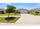 Classic home exterior with a well-maintained lawn and driveway, showcasing a welcoming and pristine curb appeal at 105 Blue Alice Spring Ct, Ruskin, FL 33570