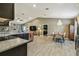 Open-concept kitchen featuring dark cabinets, stainless appliances, and view of the living and dining areas at 105 Blue Alice Spring Ct, Ruskin, FL 33570