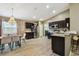 Bright kitchen with dark cabinets, stainless steel appliances, and a dining area with stylish chandelier at 105 Blue Alice Spring Ct, Ruskin, FL 33570