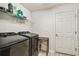 Convenient laundry room equipped with modern black washer and dryer at 105 Blue Alice Spring Ct, Ruskin, FL 33570