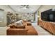 Comfortable living room with a large sectional sofa, stylish shelving unit, and sliding glass doors at 105 Blue Alice Spring Ct, Ruskin, FL 33570