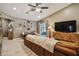 Spacious living room featuring vaulted ceilings, modern furnishings, and sliding glass doors to the outside at 105 Blue Alice Spring Ct, Ruskin, FL 33570