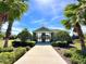 Inviting pool entrance with palm trees, landscaping, and a covered pavilion for residents' enjoyment at 105 Blue Alice Spring Ct, Ruskin, FL 33570
