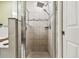 A modern tiled shower with a glass door and dual showerheads at 105 Blue Alice Spring Ct, Ruskin, FL 33570