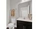 Half bathroom featuring white vanity and toilet, complete with dark wood-look floors at 11743 Lake Lucaya Dr, Riverview, FL 33579