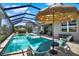 Relaxing screened pool area with a spa, covered lounge and umbrella, perfect for outdoor living at 11743 Lake Lucaya Dr, Riverview, FL 33579