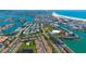 An aerial view showcases a bayside neighborhood with a pool, docks, and residential buildings at 12140 Capri S Cir, Treasure Island, FL 33706
