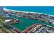Bayside community with water access, landscaping, boat docks, and views of the coastline from above at 12140 Capri S Cir, Treasure Island, FL 33706