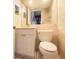 Compact half-bath featuring marble walls, pedestal sink and toilet at 12140 Capri S Cir, Treasure Island, FL 33706