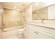 Bathroom with shower, glass screen, and white vanity with marble countertop at 12140 Capri S Cir, Treasure Island, FL 33706
