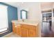 Bathroom showcases a wood vanity, sink, and large mirror with a view to the bedroom at 12140 Capri S Cir, Treasure Island, FL 33706