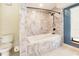 Bathroom features a tub encased in marble, complemented by black fixtures and a window with blinds at 12140 Capri S Cir, Treasure Island, FL 33706