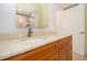 Bathroom features wood vanity with marble countertop, faucet, and a view of the tub at 12140 Capri S Cir, Treasure Island, FL 33706