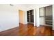 Bedroom features hardwood floors and an open closet with custom shelving at 12140 Capri S Cir, Treasure Island, FL 33706