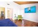 Bedroom featuring hardwood floors, chair, and TV at 12140 Capri S Cir, Treasure Island, FL 33706
