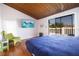 Vaulted bedroom with a wood plank ceiling and sliding door to a balcony at 12140 Capri S Cir, Treasure Island, FL 33706