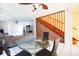 View of open concept dining room and living room with staircase at 12140 Capri S Cir, Treasure Island, FL 33706