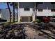 Exterior shot of unit showing private garage and guest parking with mature palm trees at 12140 Capri S Cir, Treasure Island, FL 33706