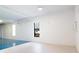 Versatile flex space with updated flooring and natural light from two windows and views of a parked car at 12140 Capri S Cir, Treasure Island, FL 33706