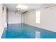 Garage features painted floors, updated lighting, and white garage door at 12140 Capri S Cir, Treasure Island, FL 33706