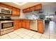 Well-lit kitchen featuring wood cabinets, granite countertops, and stainless steel appliances at 12140 Capri S Cir, Treasure Island, FL 33706