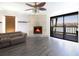 Bright living room featuring a fireplace and sliding glass doors to balcony with water view at 12140 Capri S Cir, Treasure Island, FL 33706