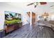 Open-concept living room features wood-look floors, modern lighting, and staircase at 12140 Capri S Cir, Treasure Island, FL 33706