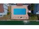 Aerial view of a rectangular community pool with plenty of seating and shimmering blue water, nestled in a tropical setting at 12140 Capri S Cir, Treasure Island, FL 33706