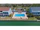 Community pool with a spacious sun deck and lounge chairs, surrounded by lush landscaping at 12140 Capri S Cir, Treasure Island, FL 33706