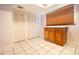 Tile-floored room featuring built in cabinets, closet, and window with blinds at 12140 Capri S Cir, Treasure Island, FL 33706