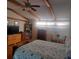 Bedroom with wood floors, vaulted ceilings, bed, dressers and a table and chairs set at 126 Philadelphia Blvd # 10, Palm Harbor, FL 34684