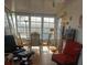 Screened patio with comfortable seating and tile floors, perfect for enjoying the outdoors at 126 Philadelphia Blvd # 10, Palm Harbor, FL 34684