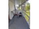 Relaxing screened-in porch with comfortable seating at 126 Philadelphia Blvd # 10, Palm Harbor, FL 34684