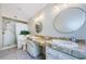 Bathroom featuring double sinks, marbled countertops, shower, and a toilet at 130 Woodcutter Ln, Palm Harbor, FL 34683