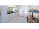 Inviting foyer featuring double doors with decorative glass, tile flooring and neutral walls at 130 Woodcutter Ln, Palm Harbor, FL 34683