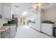 Bright kitchen featuring a skylight, white cabinets, and stainless steel appliances at 130 Woodcutter Ln, Palm Harbor, FL 34683
