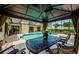 Outdoor seating area with a view of the pool and backyard at 130 Woodcutter Ln, Palm Harbor, FL 34683