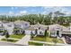 Aerial view showcasing a well-kept gray colored home with fresh landscaping, neighborhood views, and a two-car garage at 13061 Brookside Moss Dr, Riverview, FL 33579