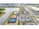 Aerial view of the pool, clubhouse, tennis courts, playground, and a lake at 13061 Brookside Moss Dr, Riverview, FL 33579
