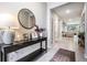 Welcoming entryway with stylish console table, decorative mirror, and neutral decor at 13061 Brookside Moss Dr, Riverview, FL 33579
