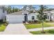 Charming single-Gathering home with a well-manicured lawn, stone accents, and a two-car garage, showcasing curb appeal at 13061 Brookside Moss Dr, Riverview, FL 33579