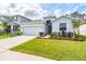 Inviting home exterior with a landscaped front yard and a spacious driveway at 13061 Brookside Moss Dr, Riverview, FL 33579